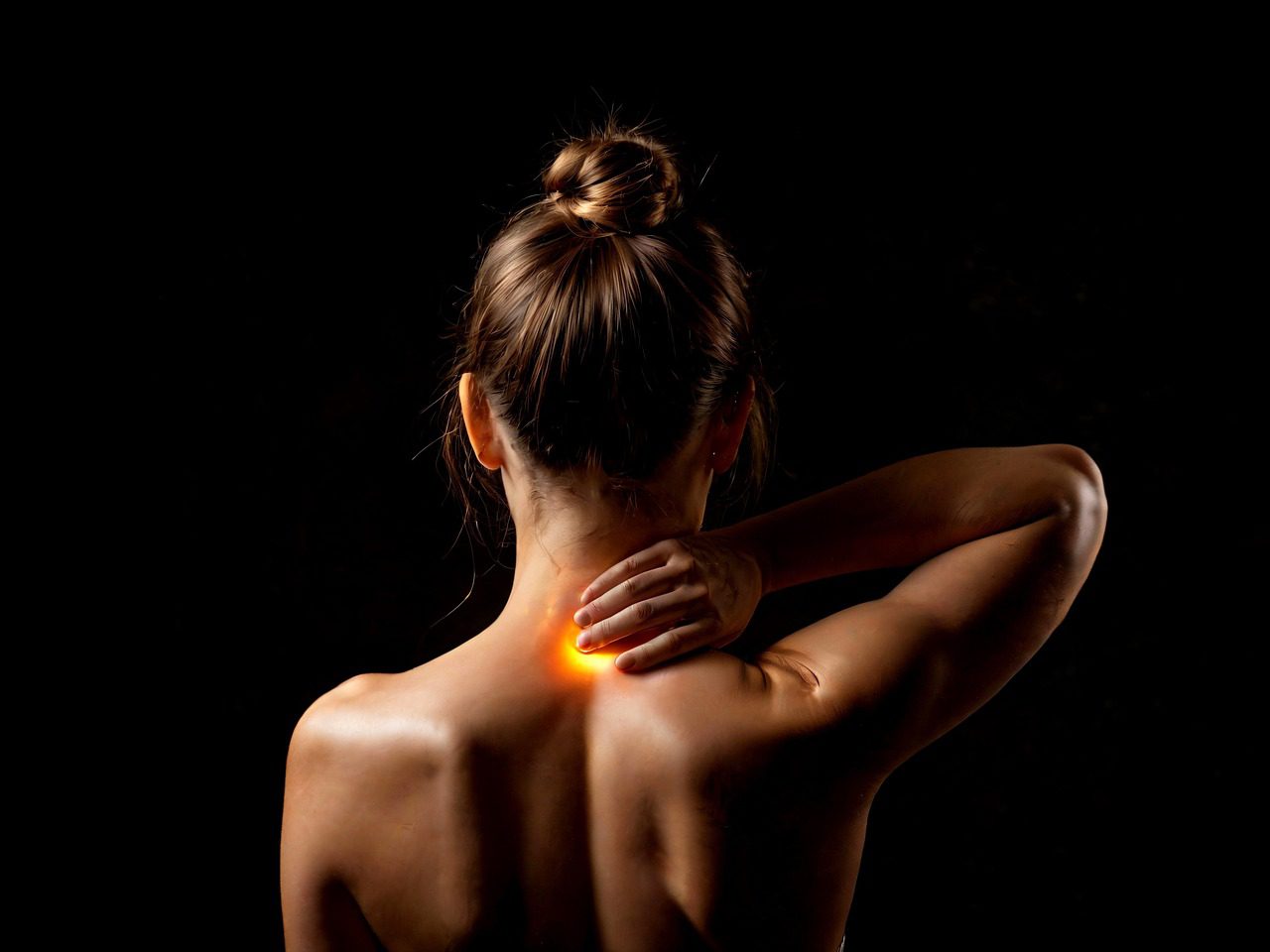 Woman with neck and back pain — orthopedic physical therapy at The Renew Studio Romeo MI